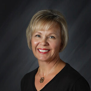 lori (002) A woman with short blonde hair smiles at the camera